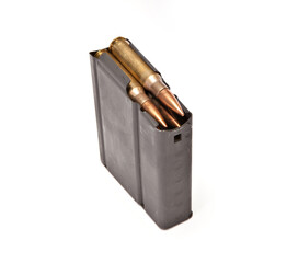 Single rifle magazine filled with rounds shot on a white background.