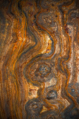 metal surface with curly rust, stains of different degrees of oxidation