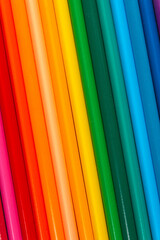 row of multicolored school pencils in a rainbow color sequence