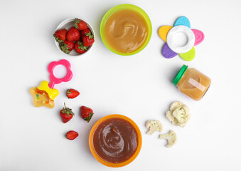 Frame of baby food, ingredients and toys on white background, flat lay. Space for text