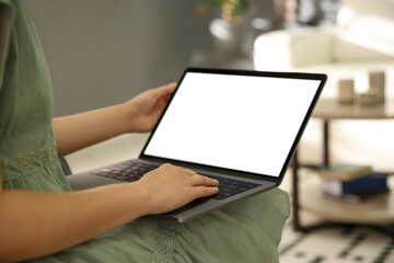 Woman using laptop at home, closeup. Space for design
