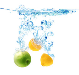 Fototapeta na wymiar Apple and lemon falling down into clear water against white background