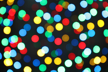 Multicolor blurred lights on black background. Bokeh effect
