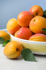 Delicious fresh ripe apricots on white table