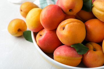 Naklejka na ściany i meble Delicious fresh ripe apricots on white table, closeup