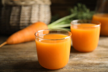 Freshly made carrot juice on wooden table