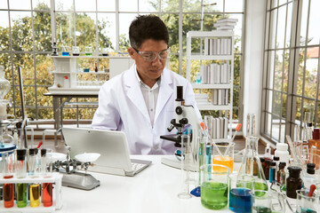 Senior scientist check experimental data  from laptop during research in laboratory