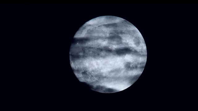 Movie of clouds on full moon in the black sky.