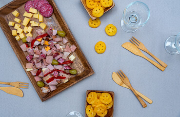 
food prepared with cheeses and cold cuts on a wooden tray and wicker to enjoy with the family