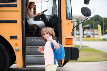 Back to school and happy time. Education: Smiling Elementary Student Ready To Board Bus.