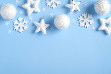 Christmas frame top border of white snowflakes, balls, snowflakes on blue background. New Year, winter holidays greeting card template, Christmas poster mockup.