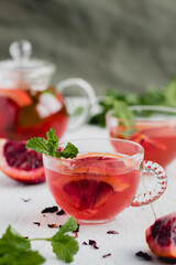 Hibiscus Tea Garnished with Blood Orange and Mint-in clear glass tea cups 