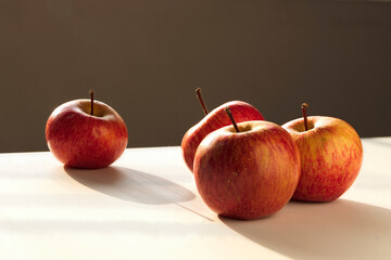 Four equal apples expressing a concept of segregation, racism, prejudice and other similar situations. Separating one and placing  to an edge. I will tell you with apples.