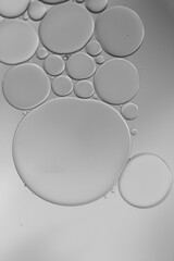 abstract oil droplets on water with circle theme and grey colour.