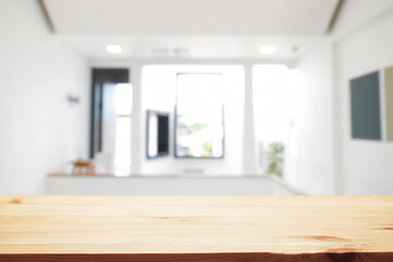 Fototapeta premium Empty wooden desk space and blurry background of home window for product display montage.