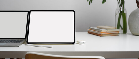 Close up view of blank screen laptop and digital tablet on white table