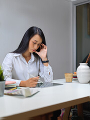 Female entrepreneur working with digital tablet on worktable in office room