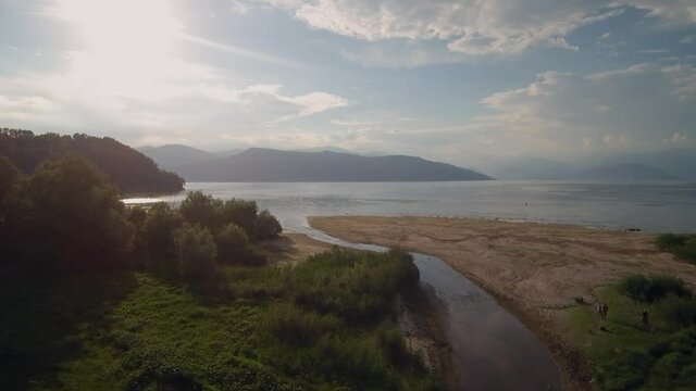 Dinamic drone shot of a small river entering the Lake Maggiore (Lago Maggiore). This lake is situated in italy in Lombardia, it connects also to Switzerland. shot filmed in Ispra (Italia).