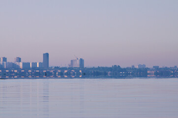 landscape silhouette of the city in a pink haze of early morning