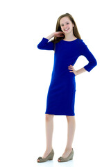 A little girl fixes her hair.