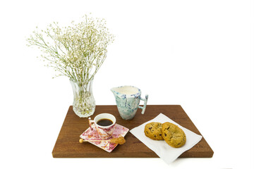 Coffee cup and milk jar with cookies