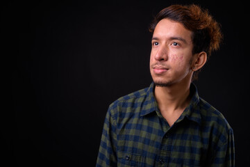 Portrait of young Asian hipster man with curly hair