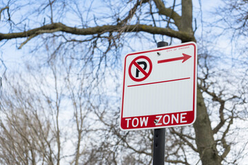 No Parking Zone and tow sign in a big city