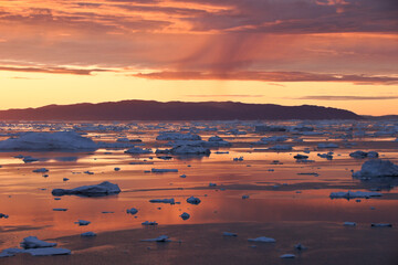 Midnight Sun and icebergs in Disko Bay, Ilulissat, West Greenland