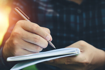 Men write a note on the paper record.