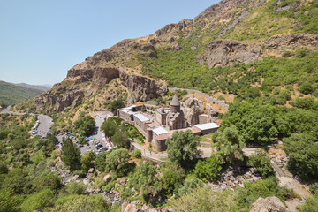 Fototapeta na wymiar beautiful scenic landscape with historic Geghard monastery on steep mountain with dramatic scenery, Armenia