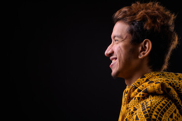 Portrait of happy young Asian man with curly hair