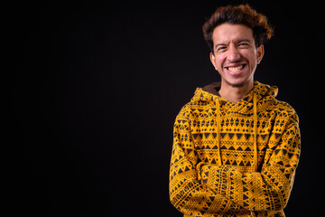Portrait of happy young Asian man with curly hair