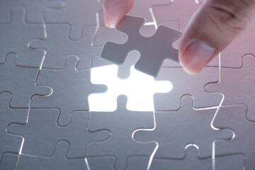 man hand holding jigsaw puzzle pieces , complete jigsaw hole.