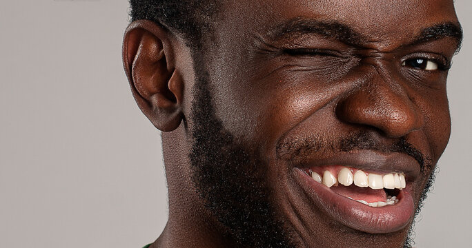 silly funny face close up of guy winking positively to camera 