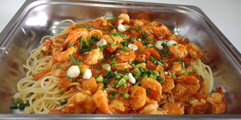 Pork spaghetti with chicken fillet on a white plate, long, thin, stiff pasta is a staple in traditional Italian cuisine. It is made from milled wheat with water, perhaps some mixed with flour, vitamin