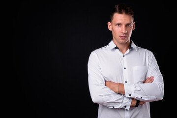 Portrait of businessman looking serious with arms crossed