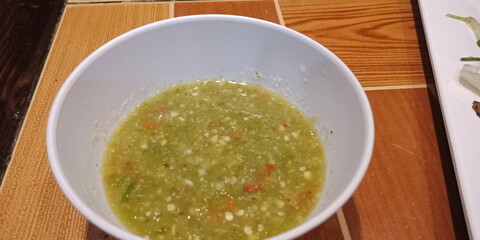the bowl of vegetable soup with basil