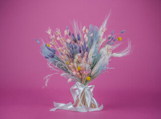 Bouquet of dried flowers on a lilac background