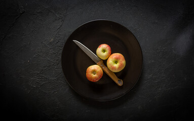 Apples served on the plate on the table