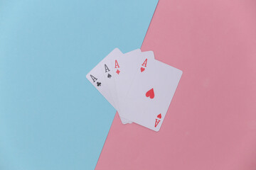 Four aces on a pink-blue background. Top view. Flat lay. Minimalism
