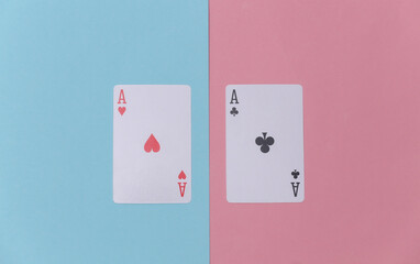 Ace of hearts and clubs on pink blue background. Top view. Flat lay