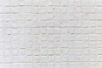 White mosaic on the wall of the house, exterior. Backgrounds and textures. Space for text. Close-up.