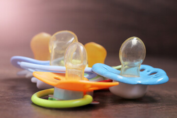 orthodontic pacifiers on a wooden background