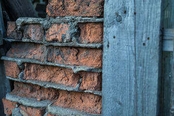 old ruined brickwork and a surface of vintage wooden boards