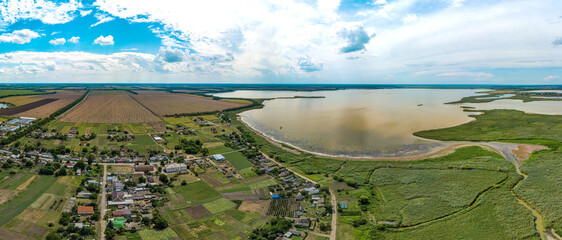 lake near the small farm Limansky (South of Russia) near the Besug River - vast fields of reeds, backwaters and lakes with the reflection of soaring clouds against the background of the blue sky