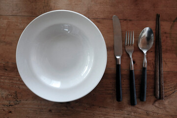 empty plate and spoon fork knife chopsticks