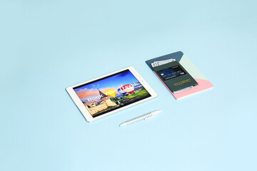 Modern tablet computer and documents on color background. Concept of online booking