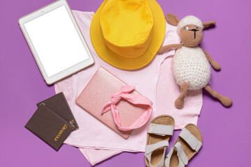 Travel accessories for children and tablet computer on color background