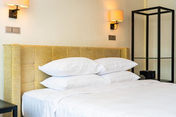 Fototapeta na wymiar White pillow and blanket with light lamp decoration interior