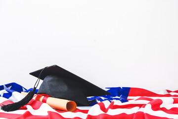 Graduation hat, USA flag  and diploma on white background